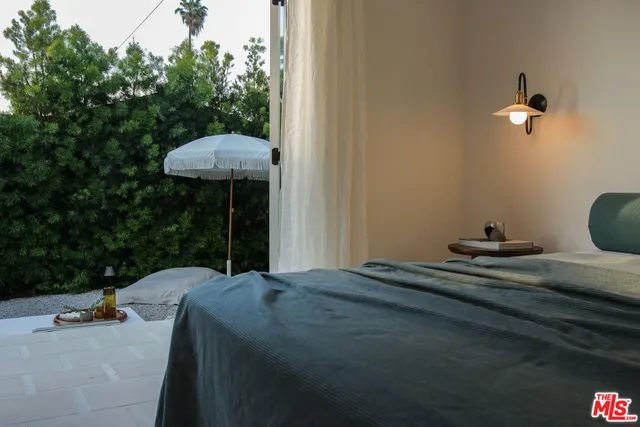 a bathroom with a tub a sink and a mirror