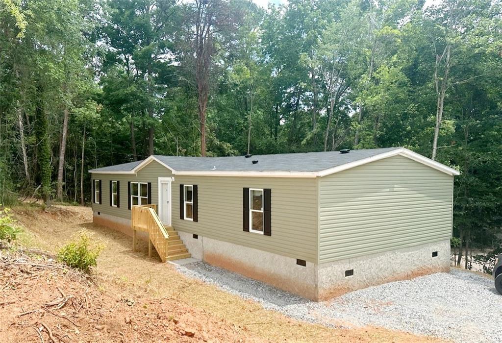 3224 Hall Drive Gainesville, GA 30501 - Photo 1 of 1 a view of a house with a backyard and trees