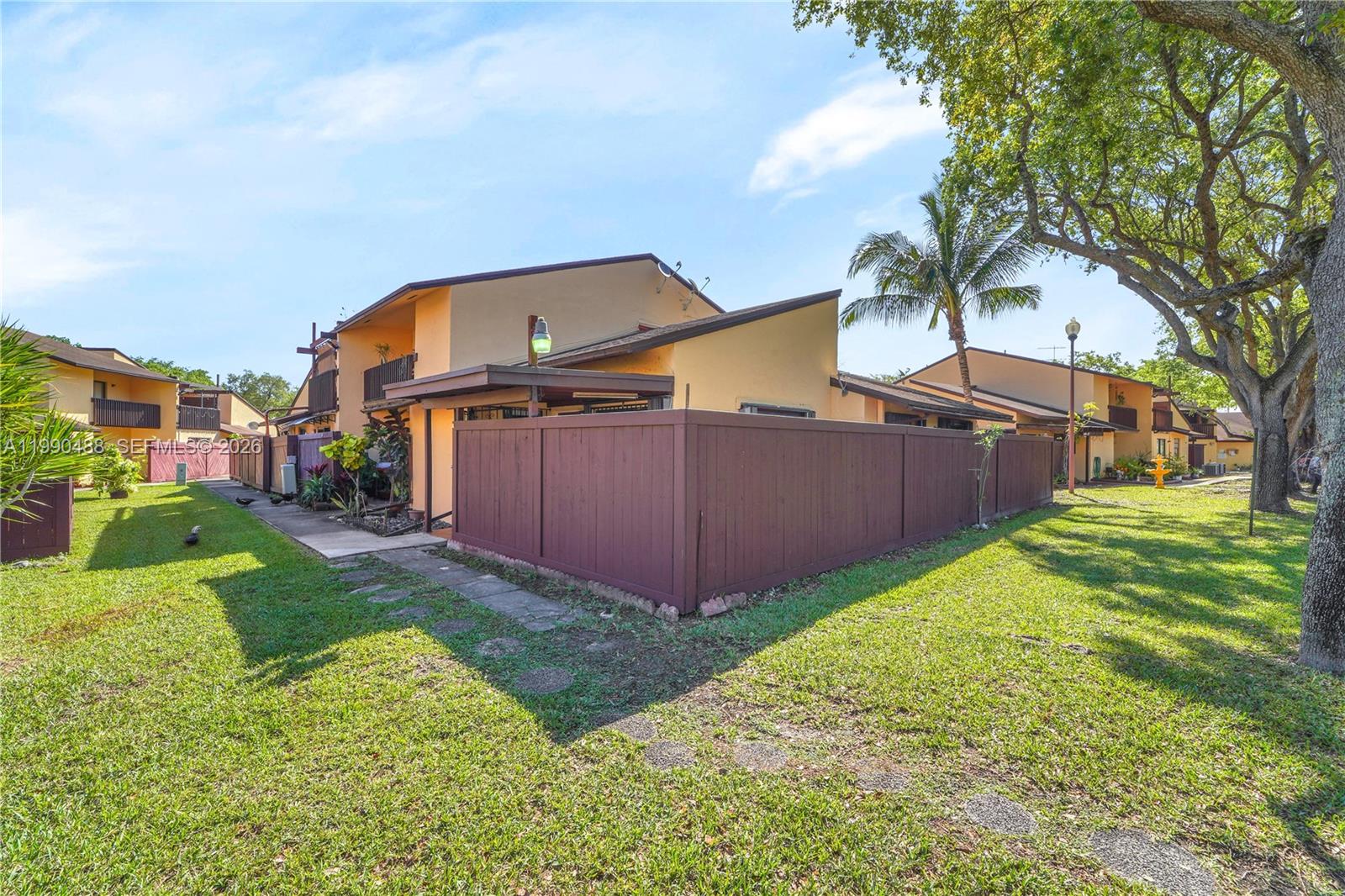 6671 Southwest 137th Court, Unit 7A Miami, FL 33183 - Photo 2 of 13 a view of a backyard with a garden and trees