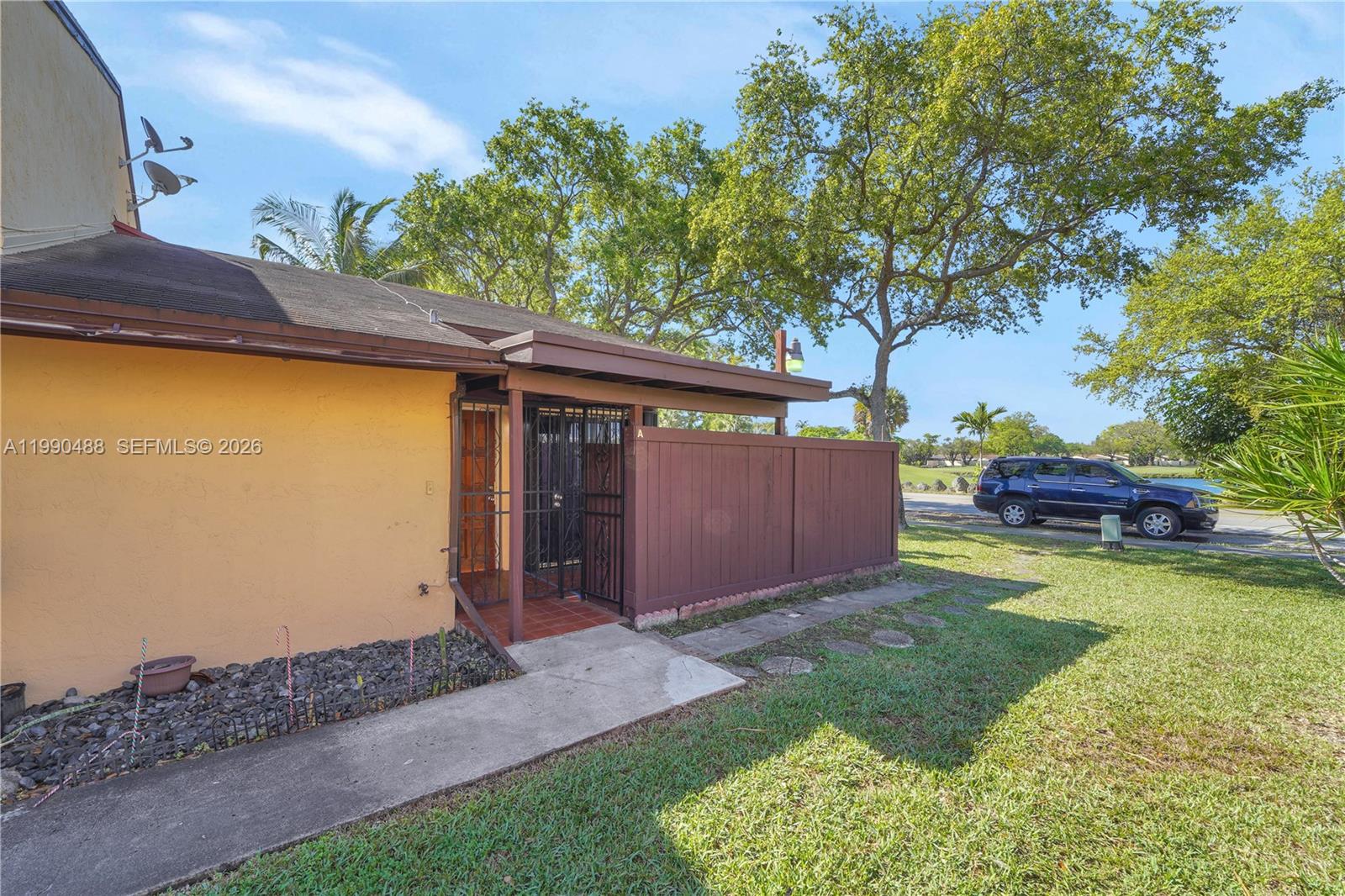 6671 Southwest 137th Court, Unit 7A Miami, FL 33183 - Photo 3 of 13 a view of a backyard with small garden