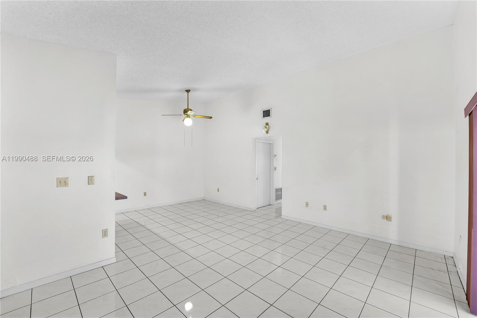 6671 Southwest 137th Court, Unit 7A Miami, FL 33183 - Photo 6 of 13 an empty room with white wall and tiles