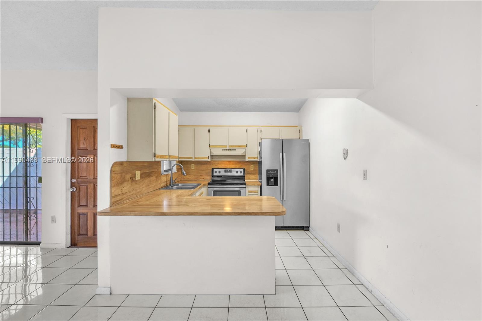 6671 Southwest 137th Court, Unit 7A Miami, FL 33183 - Photo 8 of 13 a large white kitchen with a refrigerator and a stove