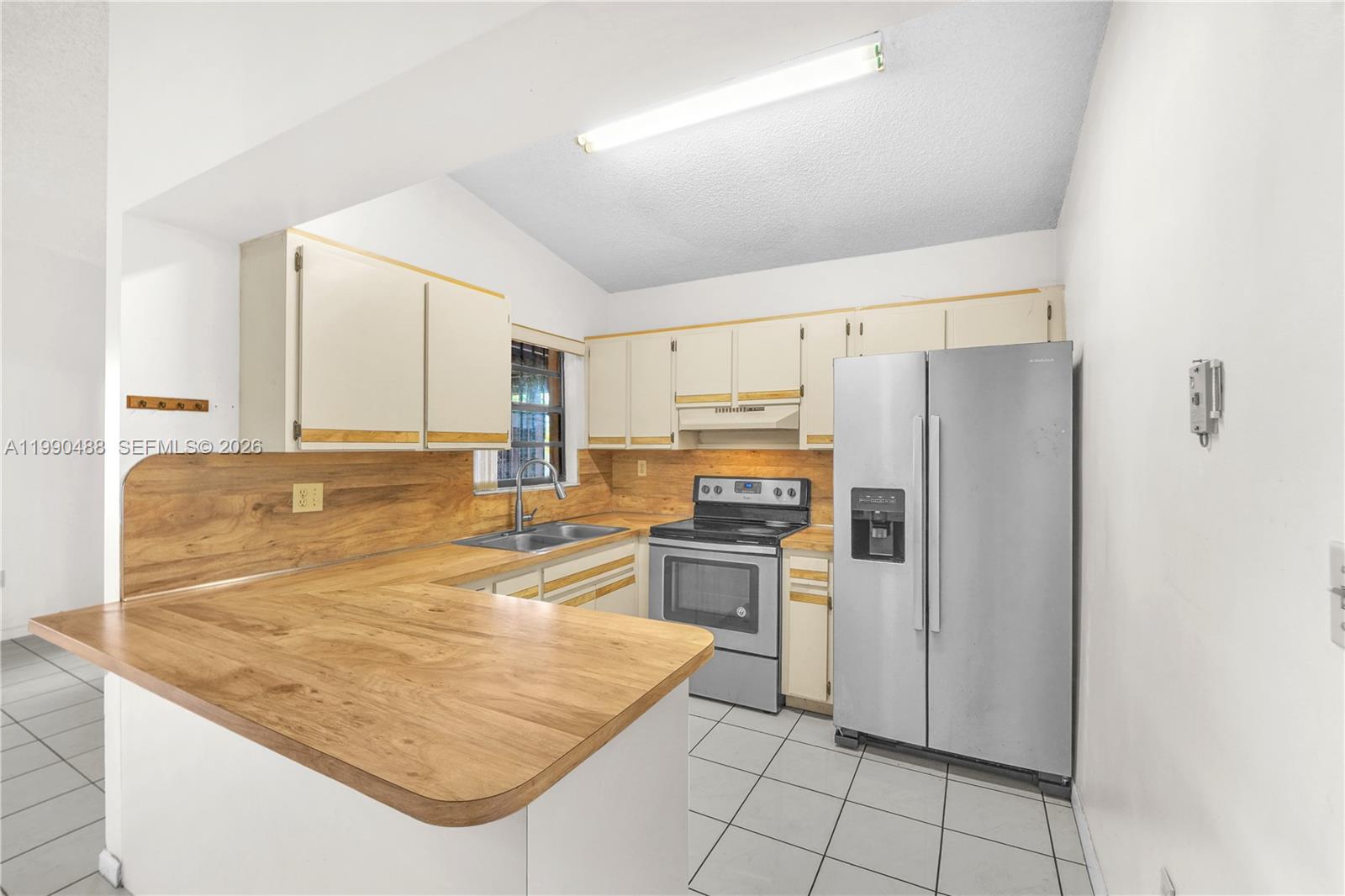 6671 Southwest 137th Court, Unit 7A Miami, FL 33183 - Photo 9 of 13 a kitchen with stainless steel appliances granite countertop a refrigerator and a stove
