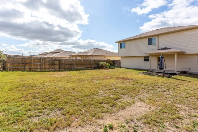 a view of an ocean with a house in the background