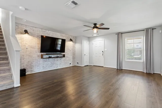 a view of livingroom with hardwood floor and a ceiling fan