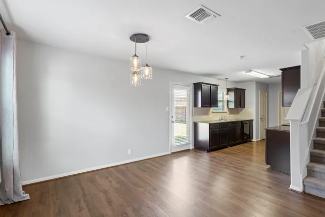 a view of kitchen with sink and refrigerator