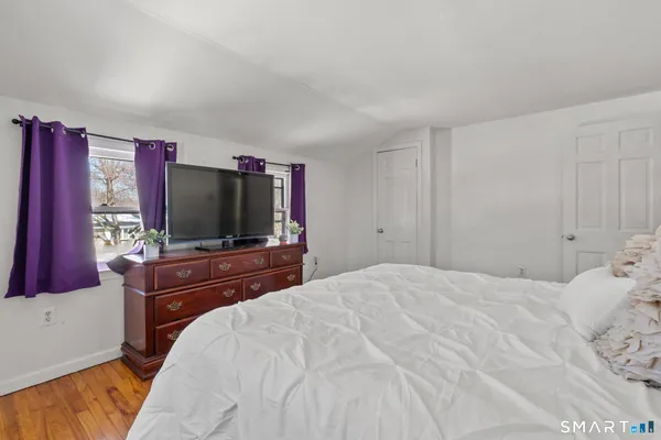 a bedroom with a bed and a flat screen tv