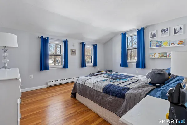 a bedroom with bed and a window