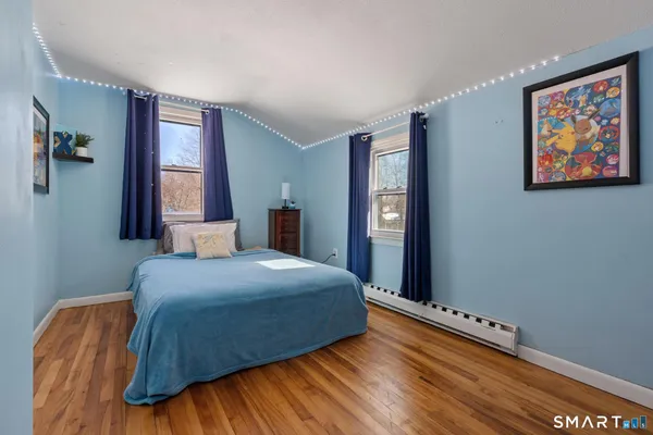 a bedroom with a bed and a painting on the wall