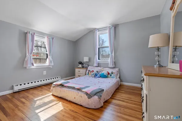 a bedroom with bed and a window