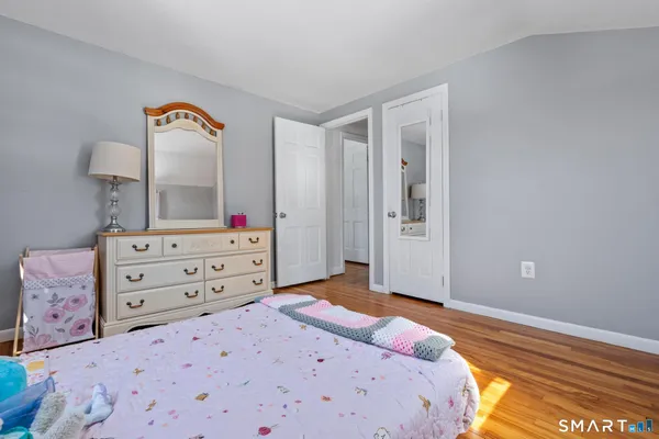 a bedroom with a bed and a dresser in it