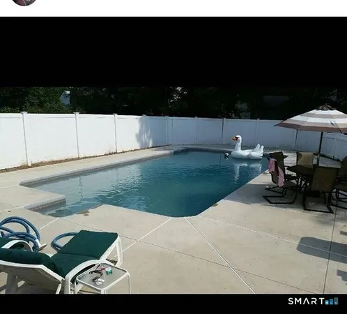 a view of backyard with seating area