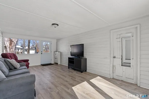 a living room with furniture and view of kitchen
