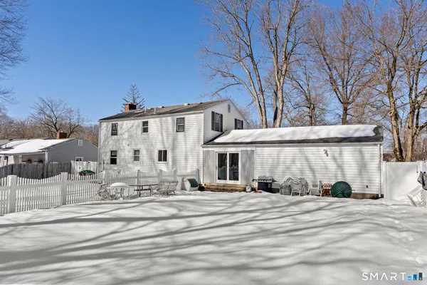 a view of a house with a snow in the yard