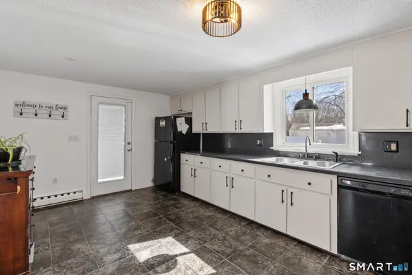 a kitchen with granite countertop a stove a sink and a granite counter top