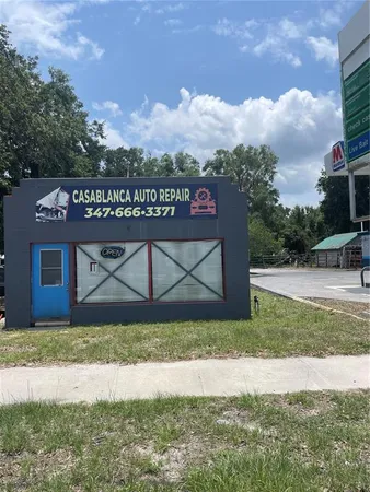 a view of house with a yard