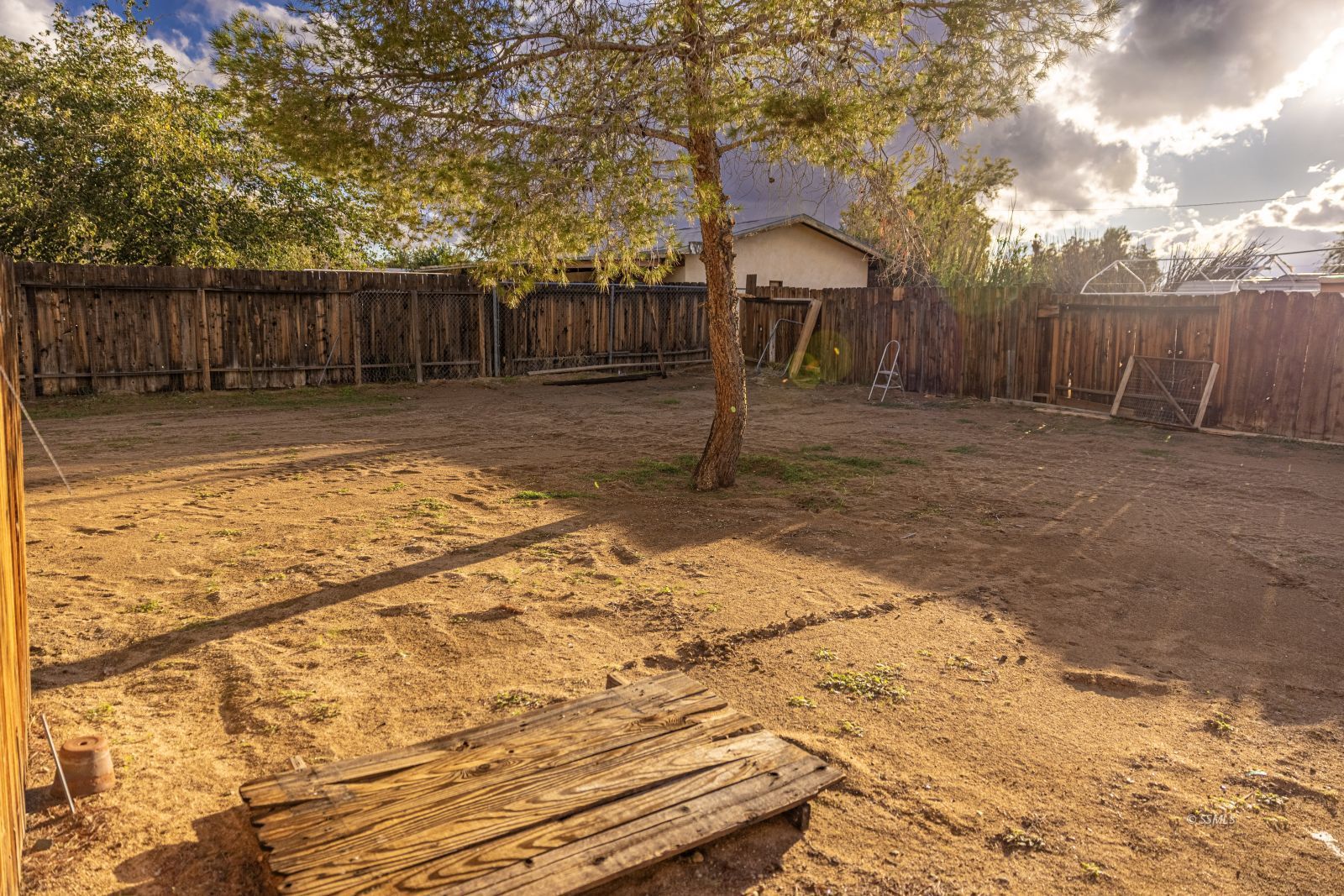 1213 Primrose Street Ridgecrest, CA 93555 - Photo 33 of 37 a backyard of a house with a yard and seating space
