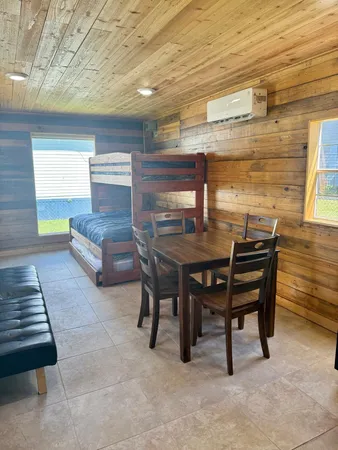 a kitchen with a table chairs refrigerator and microwave