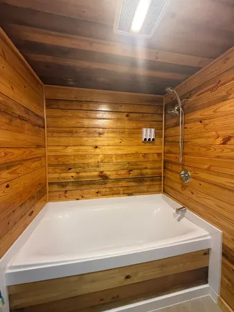 a view of a room with wooden floor