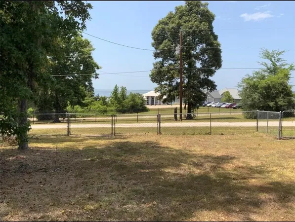 a front view of house with a garden