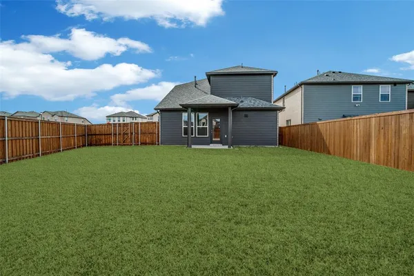 a view of a house with a backyard