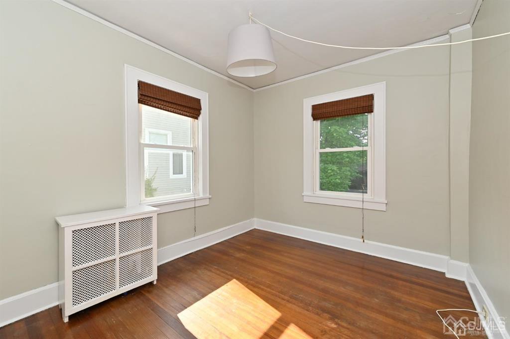 48 Christopher Street Montclair, NJ 07042 - Photo 4 of 23 an empty room with wooden floor and windows