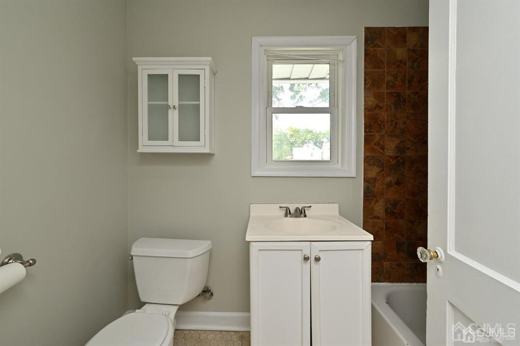 48 Christopher Street Montclair, NJ 07042 - Photo 8 of 23 a bathroom with a toilet sink and mirror