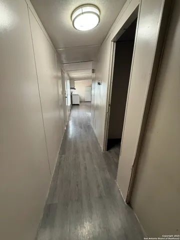 a view of a hallway view with wooden floor and staircase