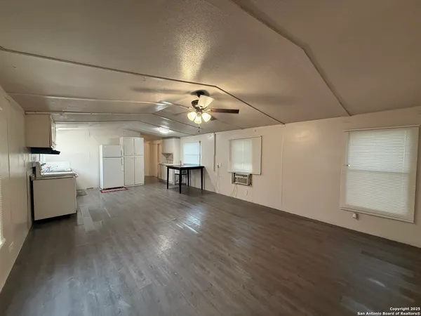 a view of a livingroom with a dishwasher cabinets and wooden floor