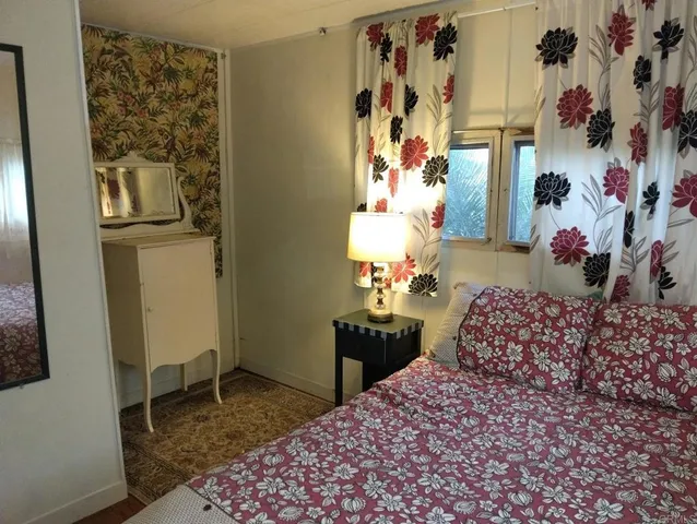 a bedroom with a bed and a table in it