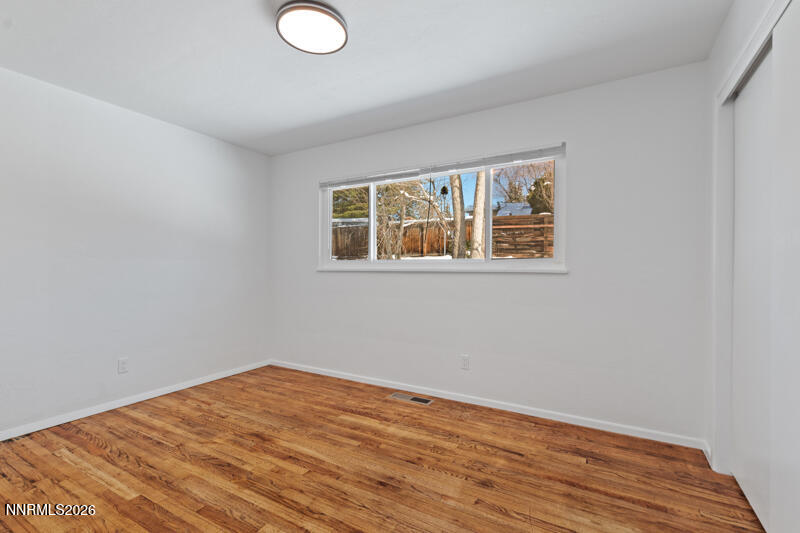 810 Lahontan Way Reno, NV 89509 - Photo 17 of 25 a view of empty room with wooden floor and fan