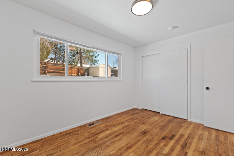 810 Lahontan Way Reno, NV 89509 - Photo 18 of 25 a view of empty room with wooden floor and fan