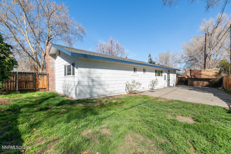 810 Lahontan Way Reno, NV 89509 - Photo 23 of 25 a view of a white house that has a small yard and large trees