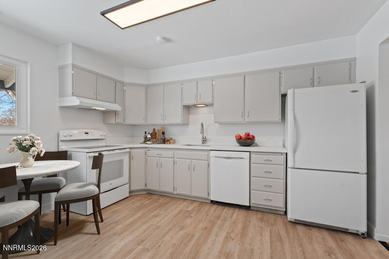 810 Lahontan Way Reno, NV 89509 - Photo 6 of 25 a kitchen with white cabinets and white appliances