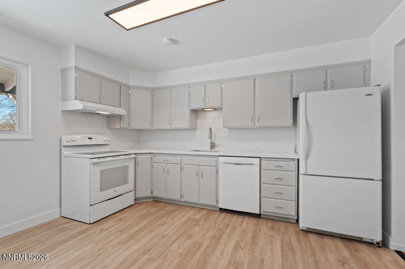 810 Lahontan Way Reno, NV 89509 - Photo 7 of 25 a kitchen with white cabinets and white appliances