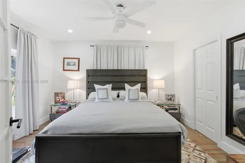 a bedroom with a bed and a tv