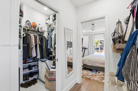 a view of walk in closet with clothes and shoes