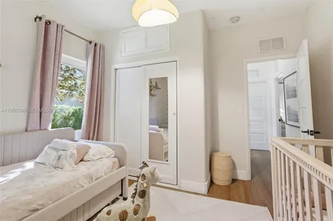 a bedroom with furniture and a window