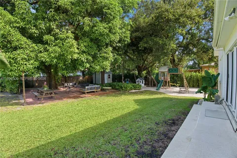 a swimming pool with outdoor seating and garden