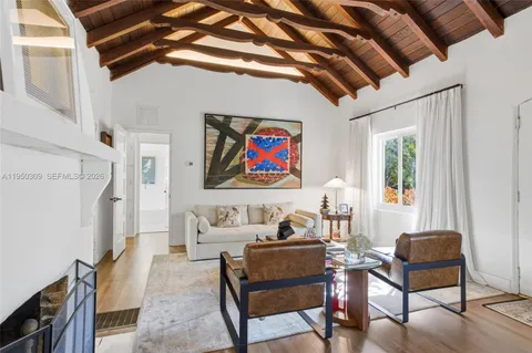 a living room with furniture a rug and a window