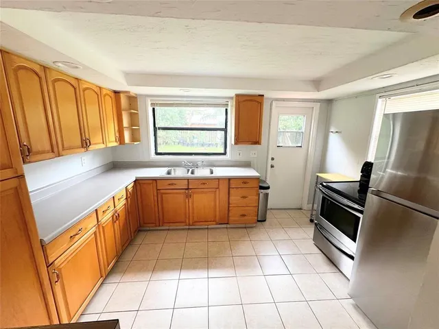 a kitchen with stainless steel appliances a sink stove and cabinets