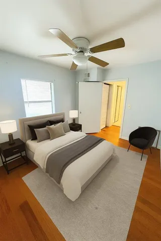 a bedroom with bed and a chandelier