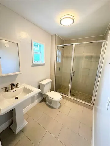 a bathroom with a sink mirror and toilet