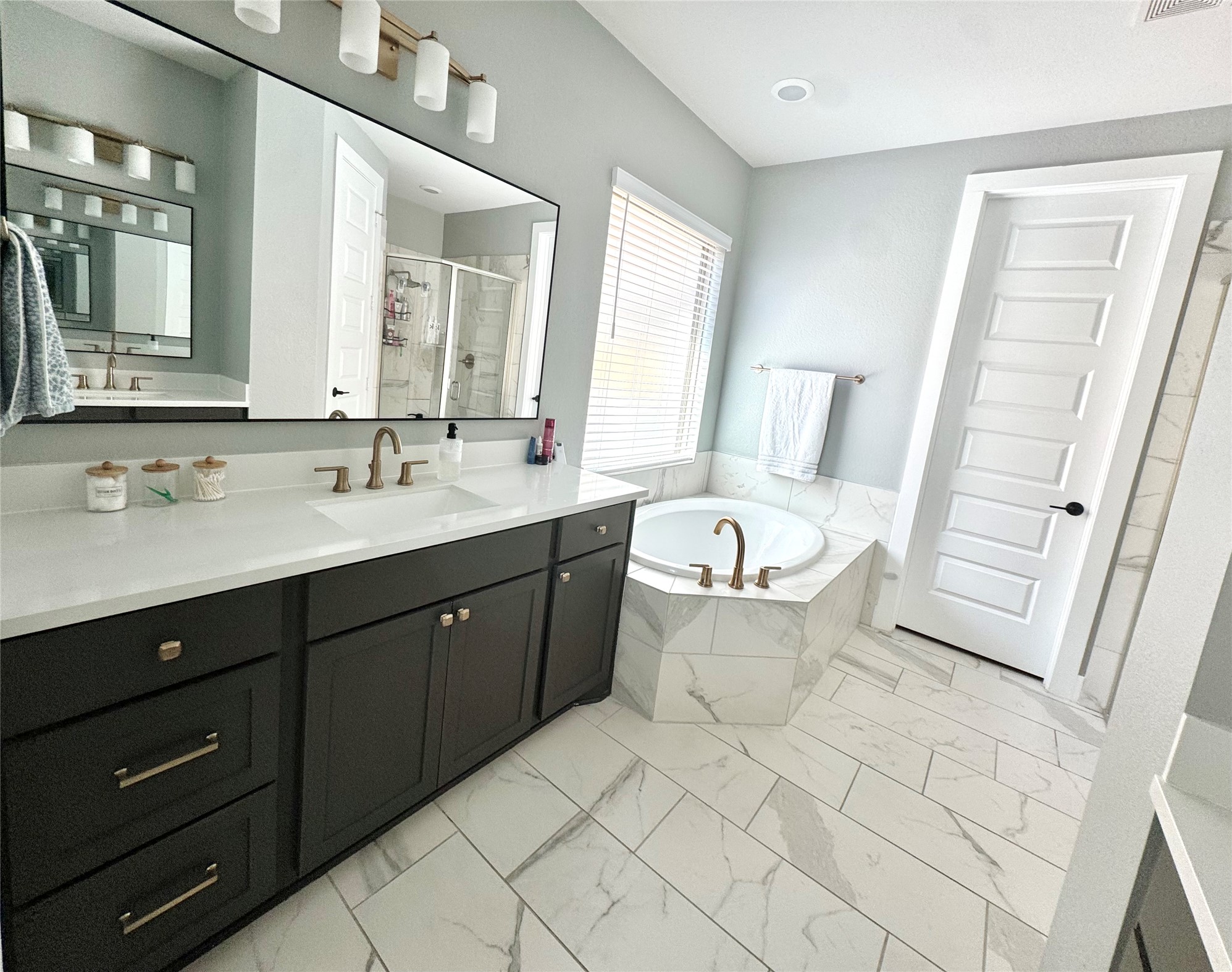 561 Cold Riv Run Kyle, TX 78640 - Photo 10 of 33 a spacious bathroom with a double vanity sink mirror and a bathtub