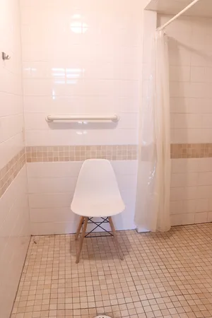 an empty room and a bathroom with windows