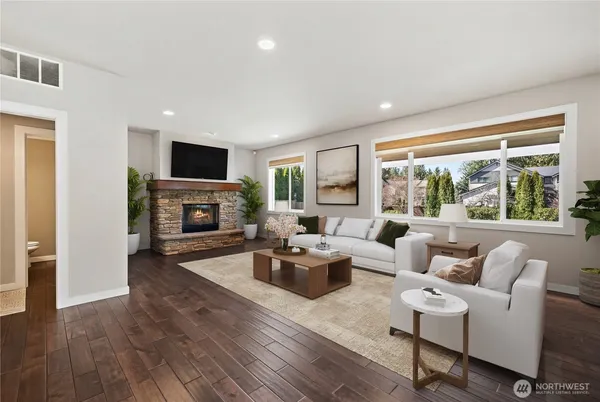 a living room with furniture a fireplace and a flat screen tv