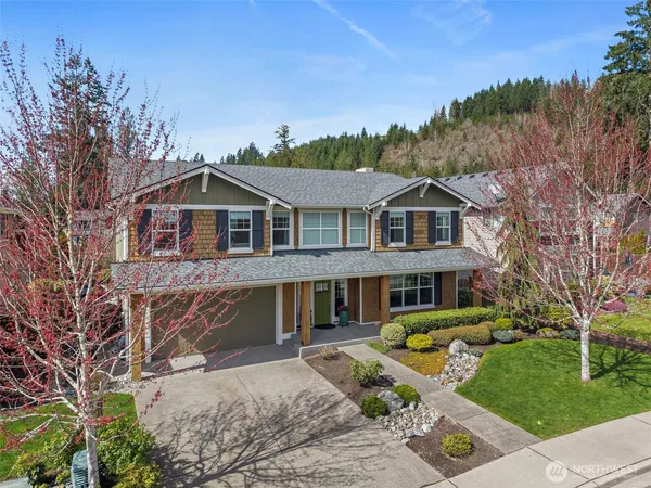 a front view of a house with a garden