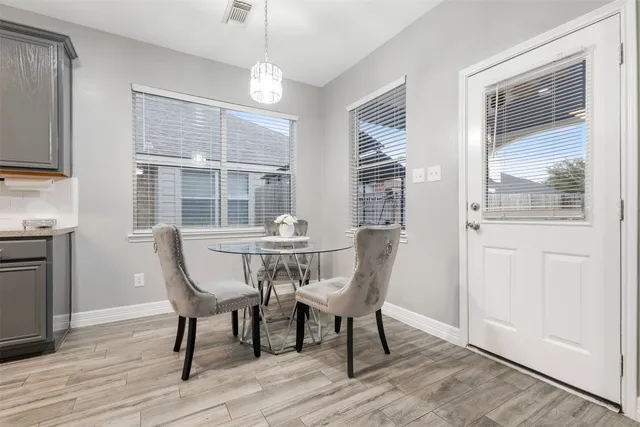 a dining room with furniture window and wooden floor
