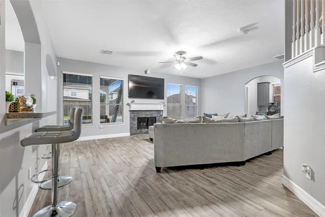 a living room with furniture a fireplace and a flat screen tv