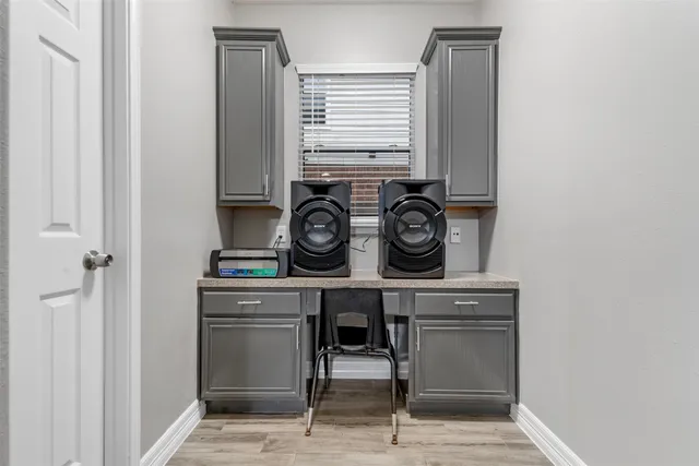 a view of washer and dryer with wooden cabinet